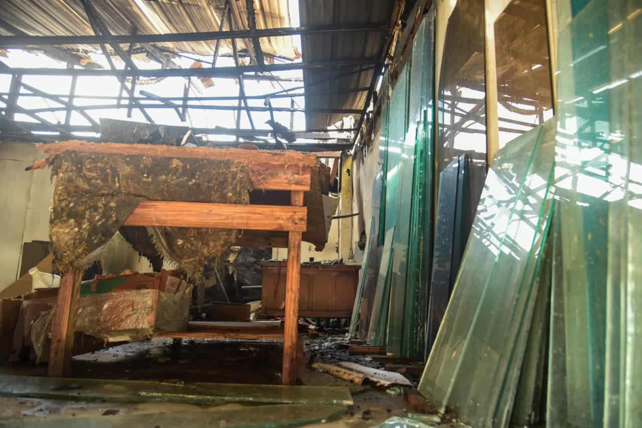 Restos de cristales rotos y escombros tras el incendio que afectó varios negocios en el sector Bella Vista, Santiago